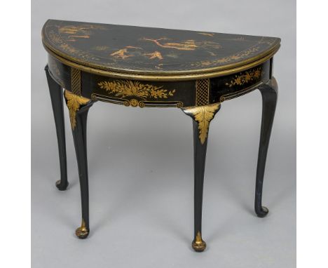 An early 20th century chinoiserie decorated demi lune card table
With typical gilt decoration on a black ground, the hinged t