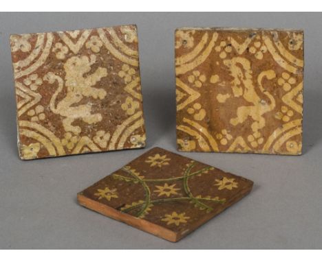 Two 17th century pottery floor tiles
Each decorated with a rampant lion on an ochre ground; together with a Spanish pottery t