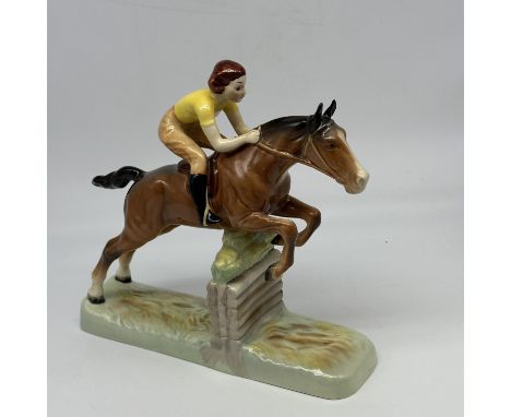 A Beswick eventing jumping horse and rider ornament, no chips or damage