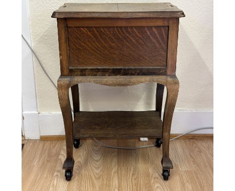 An vintage wooden trolley sewing box