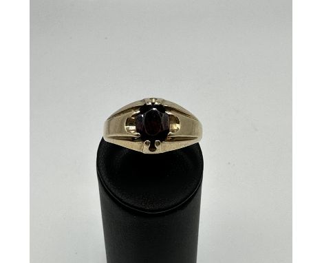 A 9ct yellow gold gents gypsy ring, single garnet stone ring, size Z +3, weight 7.8 grams approx