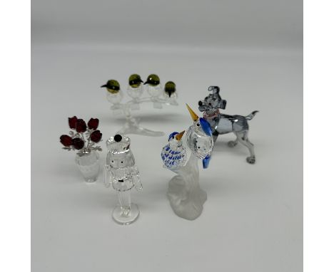 A collection of Swarovski crystal, birds, dog, flowers