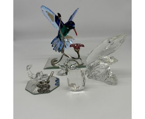 A collection of Swarovski crystal, hummingbird, whale, babies pram, flower