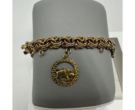 An 18ct yellow gold bracelet with 18ct yellow gold charm, bracelet is 8 inches long x 10mm wide, weight 41.5 grams approx