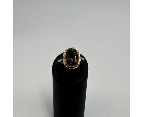 A 9ct yellow gold smokey quartz dress ring, stone size 14mm x 8mm, size Q, weight 5 grams approx, lovely condition