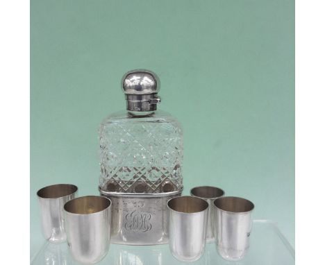 A Victorian silver mounted cut glass spirit flask with detachable base. London 1891. 14cm high. Together with a graduated set