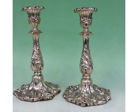 A pair of early Victorian silver candlesticks with sconces. The columns with acanthus designs. Embossed floral bases. Sheffie