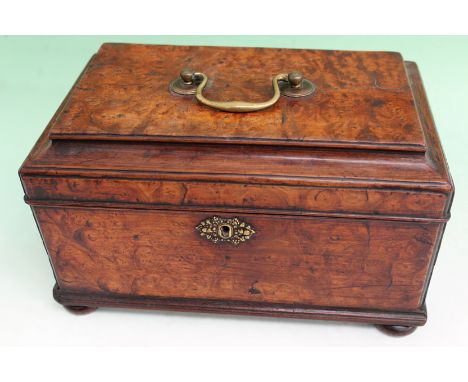 A Georgian burl walnut tea caddy. Lift top with brass handle. Divided interior. 