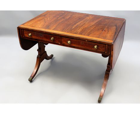 A Regency rosewood crossbanded and inlaid sofa table, two apron drawers. Trestle supports joined by scrolled stretcher. Sabre