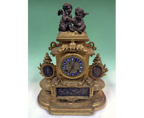 A Victorian gilt and silvered mantel clock. Surmounted with Cherubs. Silvered dial with raised enamel numerals. French striki