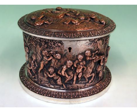 A Victorian silvered copper oval tea caddy with figural decoration. Overall scenes of cavorting putti. Fitted interior with v