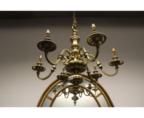 A heavy polished brass Dutch style six light chandelier. Lobed baluster shaft. Scroll arms. 60cm high.