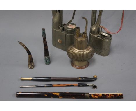 Three Chinese white metal hookah pipes together with two Japanese opium pipes with engraved and gold decoration, two further 