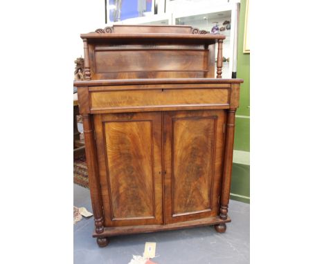 A William IV mahogany chiffonier of small size. Raised shelf gallery back over frieze drawer and cupboard doors. Flanked by c