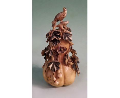 A Chinese carved ivory lidded snuff bottle of fruit form with peacock finial. 10cm high.