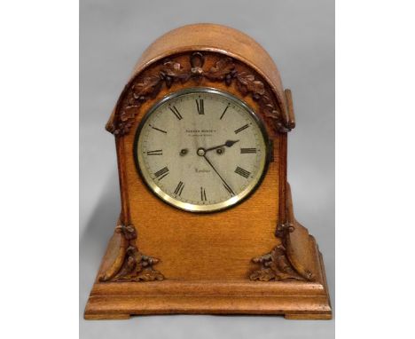 A 19th century oak cased bracket clock, arch top case with applied carved oak leaf decoration, twin train coil gong strike mo