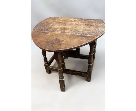 A small early oak cottage gate-leg table on turned legs with plain stretchers. 83cm wide.