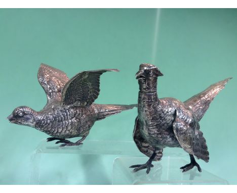 A rare pair of silver models of cock and hen pheasants. Sheffield 1925. Makers mark R H H. Approximately 20ozs. The cock 29cm