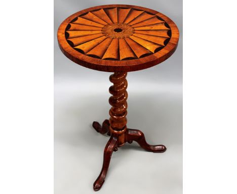 A carved and inlaid Victorian cedarwood lamp table. Circular top with radiating fan inlay. Spiral pedestal, trifid scroll leg