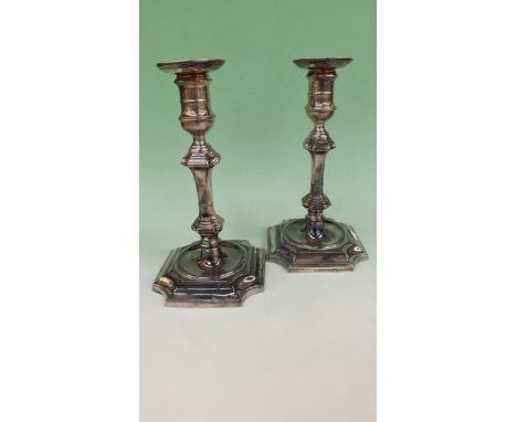 A pair of late Victorian silver table candlesticks with inverted square shaped bases, drip pan, detachable sconces. Sheffield