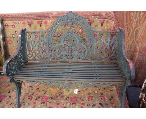 A Victorian Coalbrookdale pattern two seater cast iron garden seat with peacock fan design. Unmarked. 122cm wide. 98cm high.