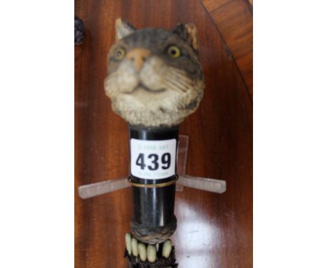 A late 19th/early 20th Century Bavarian umbrella with cat’s head, carved wooden finial to handle.