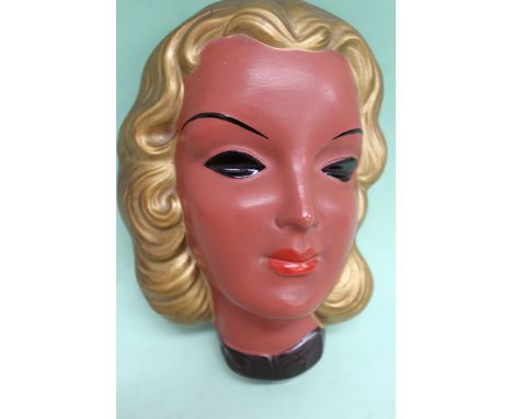 A Goldscheider pottery wall mask depicting a fashionable lady. 18cm high x 13cm wide.