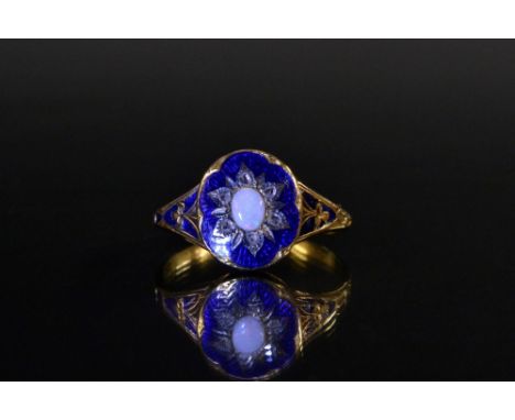 A Georgian opal diamond and enamelled ring, central oval creamy white opal flashing orange, green, blue and violet colour pla