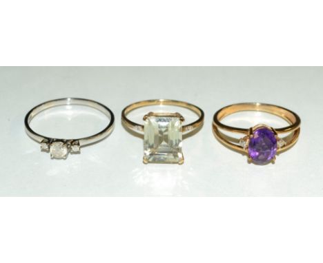 A diamond trilogy ring, approx 0.26ct, 9ct gold shank, size Q, 1.3g gross;  an amethyst and diamond trilogy ring, central ova