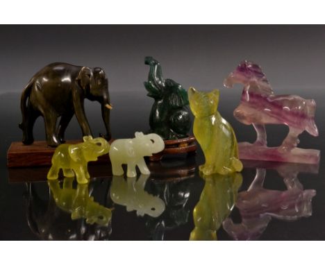 Geology - a carved dark green nephrite jade elephant, wooden base;  others pale green, yellow, horn;  etc;  a green and yello
