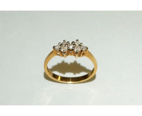 A seven stone diamond double cluster ring, round brilliant cut, total estimated diamond weight approx 0.21ct, 9ct gold shank,