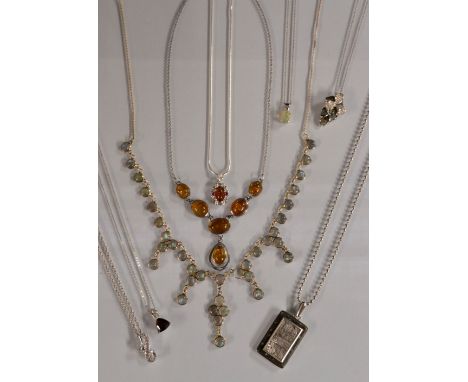 A sterling silver amber and diamond necklace, inset with six free form amber cabochons and a single diamond accent, fine chai