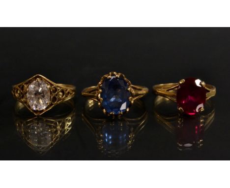 Rings - a synthetic ruby solitaire ring,  others spinel and paste, all  size N, 9ct gold shanks, 6.4g gross (3)