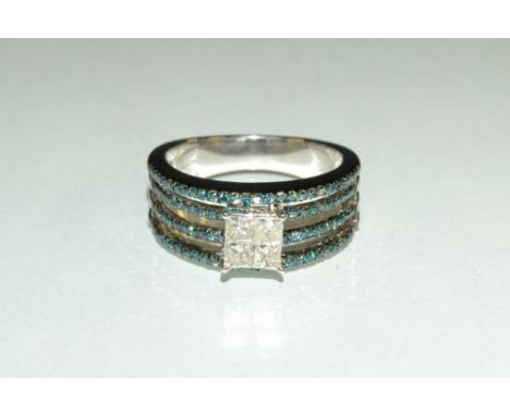 A blue and white diamond ring, central quartet of square cut white diamonds, above a four channel open shank encrusted with n