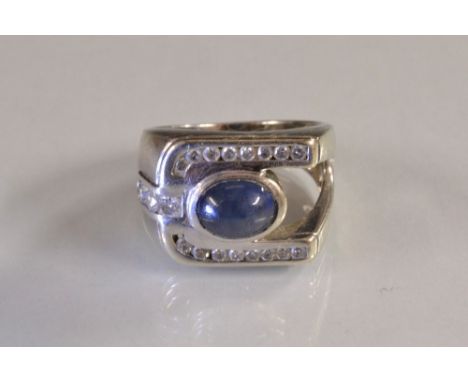 A gentleman's sapphire and diamond signet ring, central oval collet set sapphire cabochon, within an open ended box frame, in