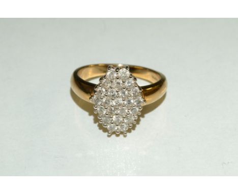 A diamond cluster ring, elongated hexagonal crest, inset with twenty three round cut diamonds, total estimated diamond weight