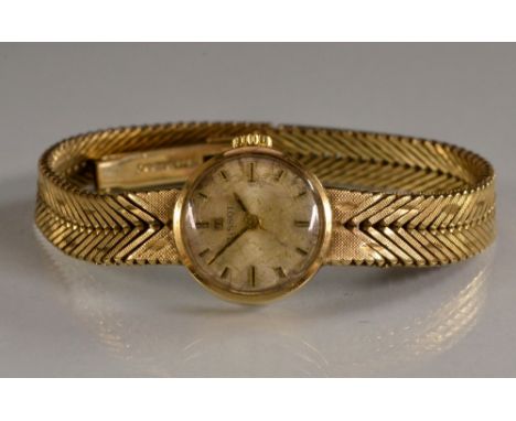 Tissot - a lady's vintage 1960s 9ct gold bracelet watch, silvered dial, baton marker, manual wind movement, integral double r