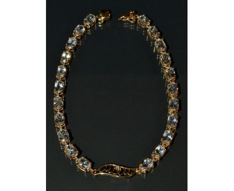 A white topaz and diamond M O M bracelet, central MOM panel inset with a single diamond accent, flanked to either side by ele