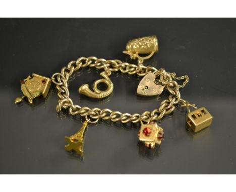 A 9ct gold charm bracelet,  suspending  thirteen assorted 9ct 18ct gold and yellow metal charms, inc cuckoo clock, tankard, c