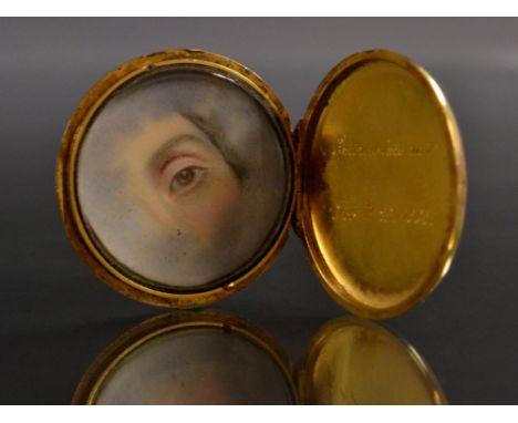 A Victorian enamelled circular portrait locket, royal blue enamelled crowned initials to front, internally engraved entered i