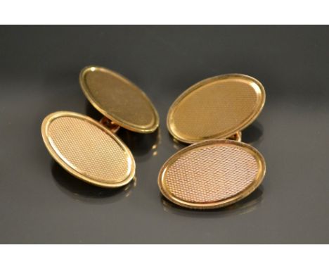 A pair of 9ct gold engine turned oval panel cufflinks, Henry Griffith & Sons Ltd, Birmingham 1968, 7.8g gross, Harrods Retail