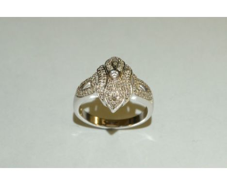 A diamond cluster ring, scrolling top inset with forty four round cut diamonds, total estimated diamond weight approx 0.45ct,