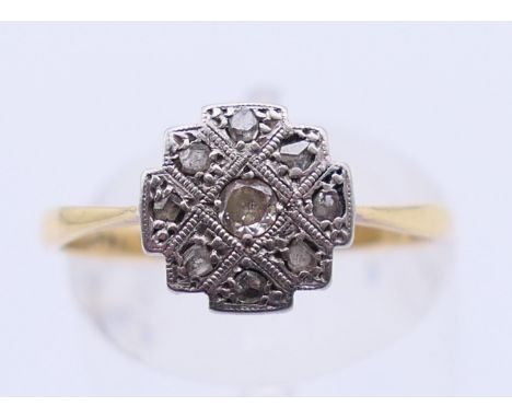 An 18 ct gold, platinum and diamond ring. 2.1 grammes total weight. Ring size O/P.