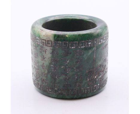 A green jade archer's ring.  3 cm high, 3.5 cm diameter.