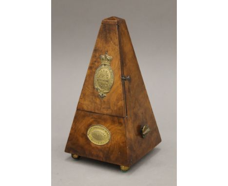 A Victorian walnut-cased metronome made by The Virgil Practice Clavier Co Ltd. 23 cm high.