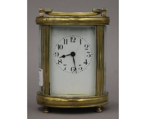 An oval brass carriage clock. 15 cm high.