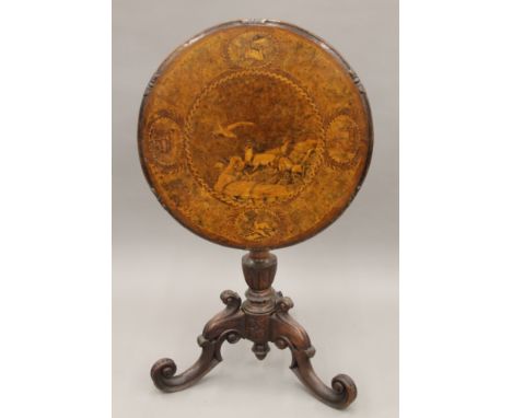 A 19th century inlaid walnut Black Forest tilt-top tripod table. 59 cm diameter.