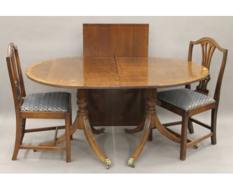 A 19th century-style mahogany twin pillar dining table and a set of six mahogany dining chairs. The former 210 cm long x 103 