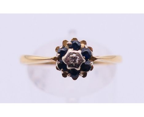 A gold diamond and sapphire ring. Ring size S/T.