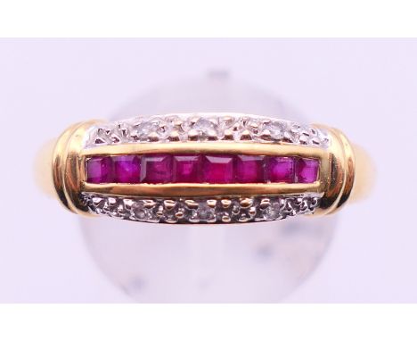 An unmarked gold, ruby and diamond ring. Ring size T. 